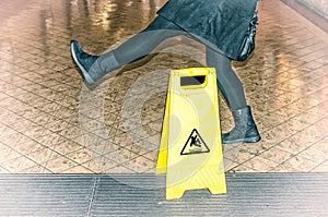 Woman almost slips on a wet floor