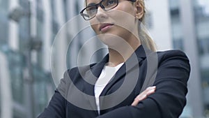 Woman with sly grin waiting for boss to complain about employees, denunciation