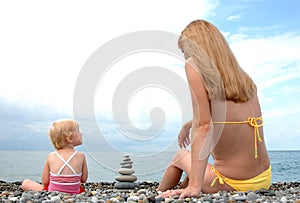 Woman and small child sit