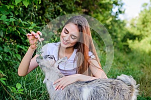 Woman and small goat green grass. Veterinarian occupation. Eco farm. Love and care. Animals law. Farm and farming