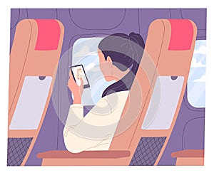 Woman with smartphone on airplane during flight