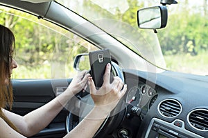 Woman with a smartphone in the car