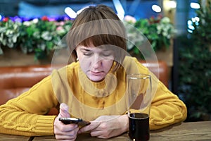 Woman with smartphone in pub