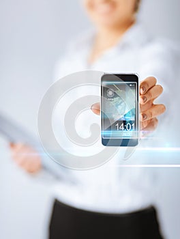 Woman with smartphone and virtual screens