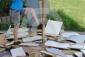 A woman smashes furniture on the floor