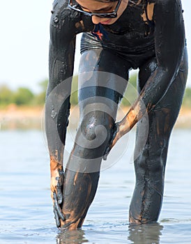 Woman smeared with mud at the salt lake Braila