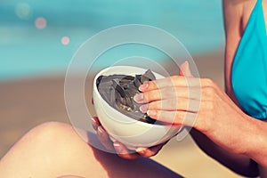 Woman smearing mud mask