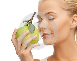 Woman smelling apple