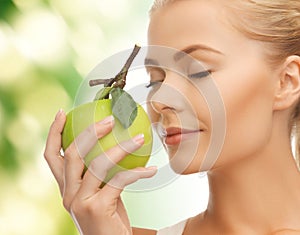 Woman smelling apple