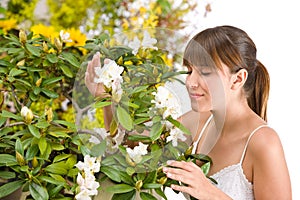 Woman smelling blossom of Rhododendron flower