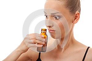 Woman smelling bottle