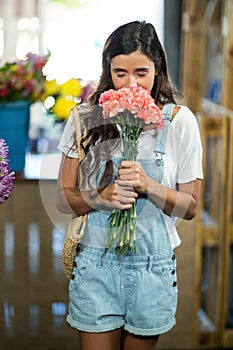 Woman smelling a bunch of flowers