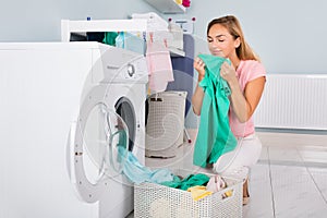 Woman Smelling Clothes After Washing