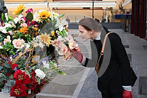 Woman Smelling Colorful Flowers