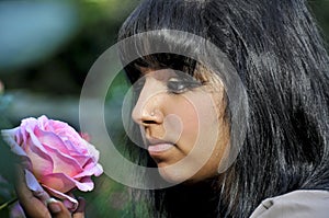Woman Smelling a Flower
