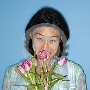 Woman smelling flowers.