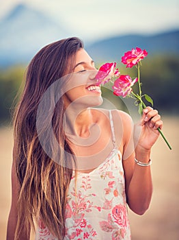 Woman smelling flowers in nature
