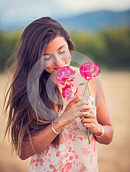 Woman smelling flowers in nature