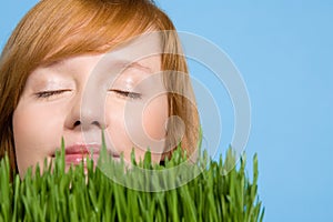 Woman smelling grass