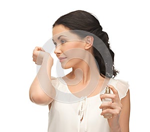 Woman smelling perfume on her hand