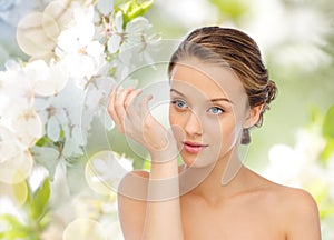 Woman smelling perfume from wrist of her hand