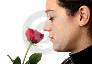 Woman smelling a red rose