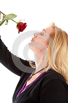 Woman smelling a red rose