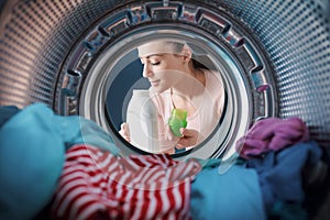 Woman smelling a scented laundry detergent photo