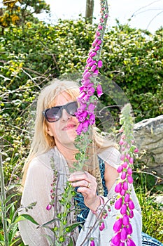 Woman smelling wild fox gloves