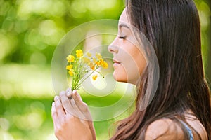 Woman smells yellow florets