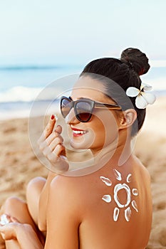 Woman smile applying sun cream  on face. Skin care. Body Sun protection. sunscreen. Female  smear  moisturizing lotion on skin.Ski