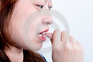 Woman is smile and  biting her fingernails, On white background