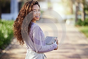 Woman with smile, books and student in campus garden, university and education with learning material for studying