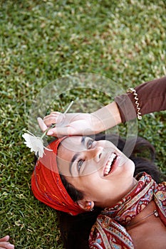 Woman, smile and flower outdoor for gypsy with plant in nature for summer and adventure in garden. Young person, lady or