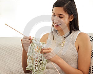 Woman, smile and knitting at home for art, handcraft and texture with peace and creativity as designer. Female person