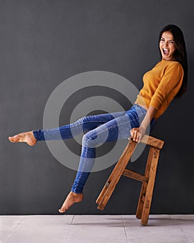 Woman, smile and portrait on chair for clothes, trend and style for fashion and bold color for weekend. Female person