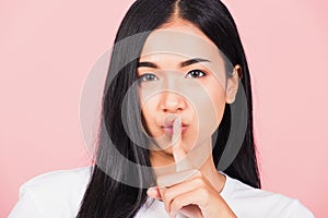 Woman smile stand making finger on lips mouth silent quiet gesture