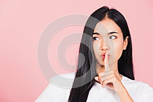 Woman smile stand making finger on lips mouth silent quiet gesture