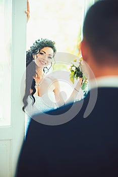 Woman smile to man on wedding day. Happy bride and groom. Sensual woman with bridal makeup and hairstyle. Fashion girl