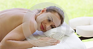 Woman smiles at camera while at spa