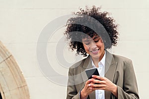 woman smiles happy sending message with her phone