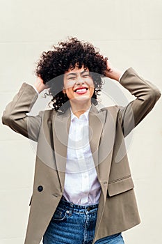 woman smiles happy shaking her curly hair