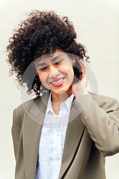 woman smiles happy touching her curly hair