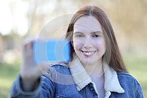 Woman smiles looking at the camera and showing her credit card