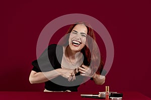 Woman smiling against an isolated red background.