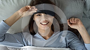 Woman smiling in the bed after waking up