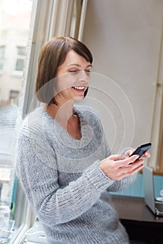 Woman smiling with cell phone