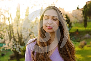 Woman smiling with closed eyes taking deep breath celebrating freedom. Positive human emotion face expression feeling life