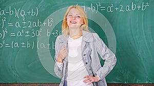 Woman smiling educator classroom chalkboard background. Working conditions which prospective teachers must consider