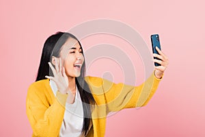 Woman smiling excited  making selfie photo, video call on smartphone